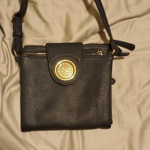 Black purse with gold zippers and button